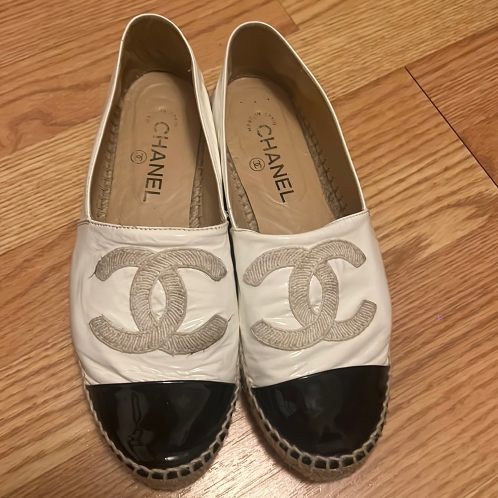 Black and white Chanel leather slip Ons. Authentic.